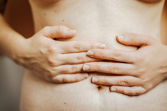 The GI-MAP Gut test - woman holding stomach